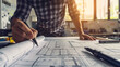 © Théo - A visionary architect sketching blueprints for an innovative building design in their studio.