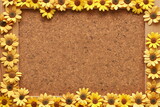 Fototapeta  - Cork board with yellow flowers sunflowers pasted on it, frame background. Free space for text or greeting  
