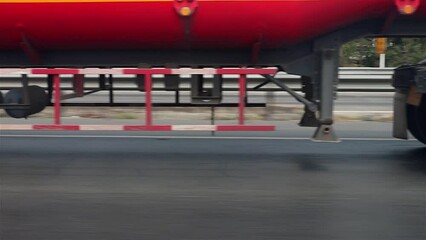 Wall Mural - View of the wheels of a cistern truck while driving on a highway