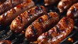 Close-up shot of plump sausages with visible grill marks, glistening with a glaze.