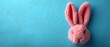 a pink bunny head hanging on a blue wall with a blue wall behind it and a blue wall behind it.