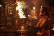 An atmospheric image capturing a Hindu priest during a traditional fire ritual at a dimly-lit temple