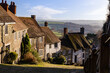 Gold Hill in Shaftesbury, Dorset, with attractive countryside backdrop