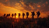 Fototapeta Uliczki - A group of soldiers are walking in a field at sunset. The sun is setting behind them, casting a warm glow over the scene. The soldiers are wearing backpacks and appear to be on a long journey