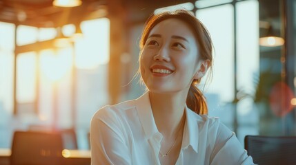 Wall Mural - A young woman smiling while bathed in the warm golden hour light of a setting sun, indoors