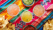 Top view Classic lime margaritas with nachos and tacos Cico de Mayo traditional food on a bright Mexican, table cloth