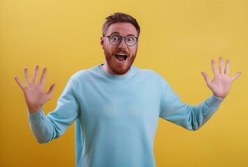 Wall Mural - a man with glasses and beard wearing a blue sweater stands out showing hands