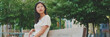 © Andrii Nekrasov - Beautiful brunette girl is enjoys relaxing while sitting on bench in city park, Panorama