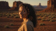 Bellissima donna con capelli ricci  sorride felice durante una vacanza nella Monument Valley negli Stati Uniti d'America