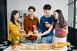 © Nuttapong punna - Group of Young Asian friend having, enjoy evening party together at home. Attractive young man and woman having fun, eating food, celebrate at home