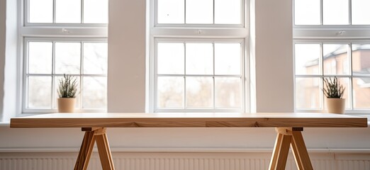 Poster - Step into the inviting ambiance of a kitchen adorned with a wooden table and chairs, its blurred background enhancing the sense of comfort and intimacy.