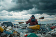 a man seen from behind canoeing through a sea of rubbish