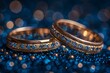 Two Gold Wedding Rings With Blue Diamonds