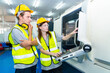 © CandyRetriever  - Manufacturing industry factory manufacturing technology concept. Caucasian man and woman engineer worker in safety wear working and maintaining control CNC lathe machine system in factory plant room.