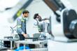 © CandyRetriever  - Manufacturing, industry technology and science concept. Male technician engineer teamwork checking and maintenance electric robotic machine arm system with computer software in factory laboratory.