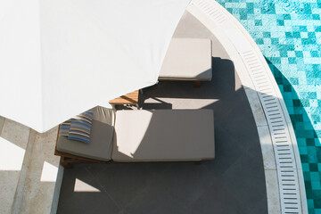 Wall Mural - Pool area with sunbeds in the shade of beach umbrellas