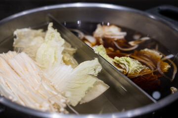 Wall Mural - Boiling sukiyaki soup. It’s ready for cooking. Soup has different two soups. It has a lot of meats and vegetables. It had good taste