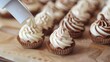 Chocolate cupcakes with whipped cream on parchment paper, selective focus
