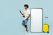 © ViDi Studio - Traveler man wears white casual clothes big blank screen mobile cell phone use smartphone isolated on plain blue background. Tourist travel abroad in free time rest getaway. Air flight trip concept.