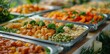 line of food trays filled with delicious and colorful dishes, including potatoes, broccoli, carrots, beans and rice