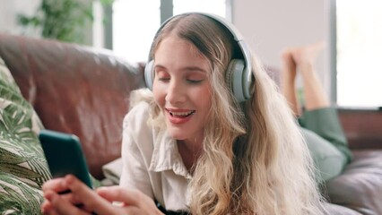 Sticker - Woman, headphones and music with cellphone on couch, singing and update on social media in home. Young person, streaming and mobile app for online radio with subscription, relax and weekend on sofa