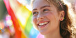 Photo of a broadly smiling and happy girl at a gay pride parade, close-up, image to copy on the left