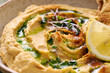 Delicious homemade hummus with lemon, paprika, olive oil and microgreens. Vegetarian Middle Eastern dish