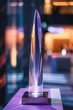 A sleek, modern award for technology innovation, made of glass and metal, shines at a tech industry gala, highlighting cuttingedge achievements