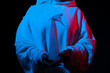 © Sergey - Person in hoodie with spray bottle, under red and blue light effects