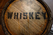 wood Whiskey barrel with black stamped letters spelling whiskey