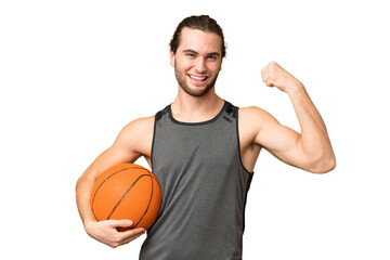 Wall Mural - Young handsome man isolated on green chroma background playing basketball and proud of himself