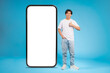 Teen with thumbs up beside large smartphone mockup