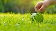 Hand saving a coin in a green piggy bank on sunny grass. Concept of eco-friendly savings. Simple and clear financial image. Perfect for finance and nature themes. AI