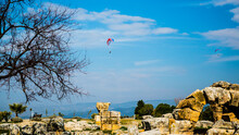 Pamukkale, Turkey - March 26 2014: Parachute Sports In Pamukkale With White Travertine Terraces In Background