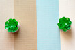 two green artificial decors on a brown and blue striped tablecloth. Free place for text and logo