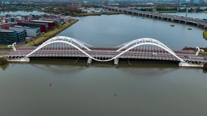 Wall Mural - Aerial drone view of modern Enneus Heerma Bridge Amsterdam Netherlands. High quality 4k footage