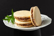 Three delicious alfajores filled with dulce de leche, sprinkled with grated coconut...