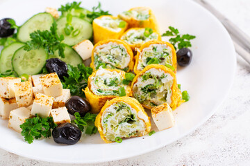 Wall Mural - Healthy breakfast. Roll omelette, feta cheese and cucumber salad. Keto, ketogenic lunch.