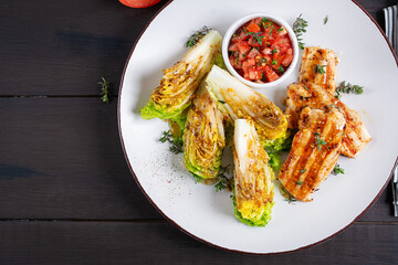 Wall Mural - Keto lunch or dinner. Grilled chicken fillet with mini romen and tomatoes salsa. Top view, flat lay