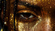 Close-up of a person's eye with golden glitter makeup, artistic and dramatic