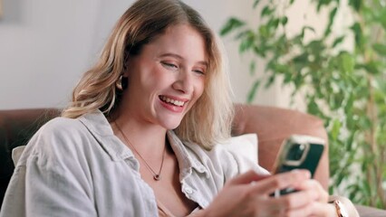 Poster - Woman, cellphone and laughing for online social media at home for digital communication, networking or scroll. Female person, sofa and smartphone reading in apartment for relax, search or internet