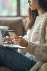 Aufkleber - A woman sitting on a couch using a laptop computer. Suitable for technology and lifestyle concepts
