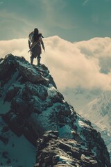 Wall Mural - Man standing on top of a snow covered mountain, suitable for outdoor and adventure concepts