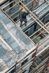 Poster - A man standing on top of a building under construction. Suitable for construction industry concepts