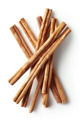 Poster - A pile of cinnamon sticks on a white surface, perfect for food and spice related projects