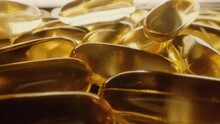 Cod Liver Fish Oil Gel Capsules. Omega 3 6 9 Golden Fish Fat Pills. 4K ProRes