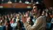 © ANC Media - A man in a theatre clapping with a crowd behind him