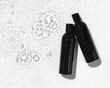 Black Shampoo and Conditioner set with water splash background