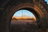Fototapeta  - Shot of volcano through a old tire in San Pedro de Atacama, Chile