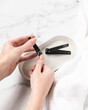 Woman clipping nails over trendy and modern bathroom counter